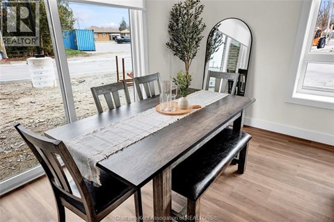 A dining room with a wooden table and chairs.