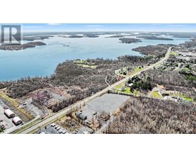 An aerial view of a construction site with a body of water in the background.