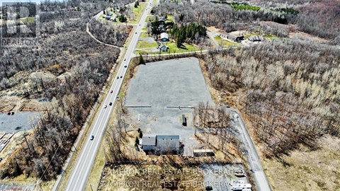 An aerial view of a real estate brokerage office surrounded by trees.