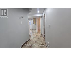 A hallway with a tiled floor and white walls.