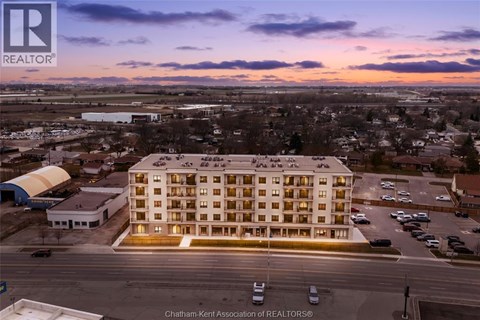 A large building with a parking lot in front of it.