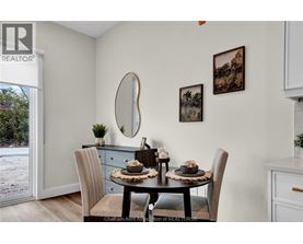 A dining room with a table set for two and a view of a snowy landscape outside.