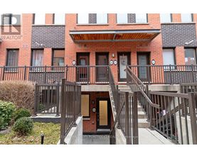 A building with a balcony and a door in the center.