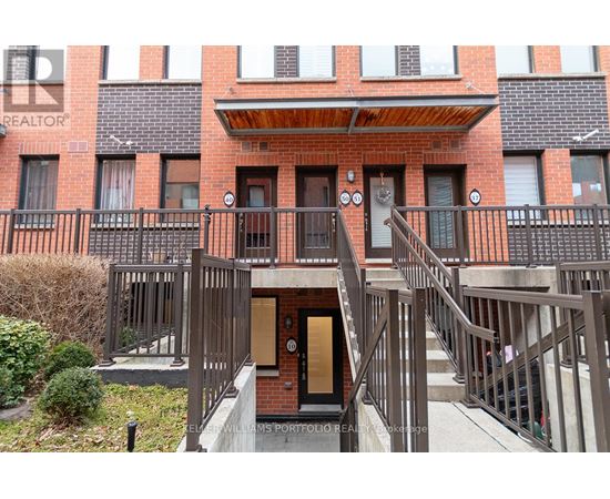 A building with a balcony and a door in the center.