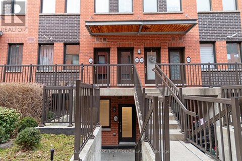 A building with a balcony and a door in the center.