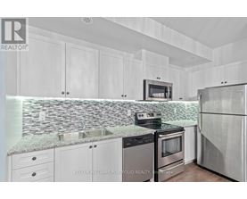 A kitchen with white cabinets and a granite countertop.