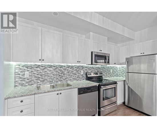 A kitchen with white cabinets and a granite countertop.
