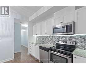 A kitchen with white cabinets and a black stove top oven.