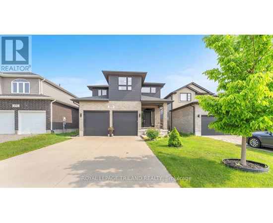 A large, well-maintained house with a driveway in front is for sale.