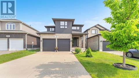 A large, well-maintained house with a driveway in front is for sale.