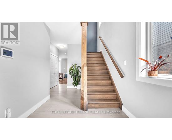 A staircase with wooden steps and a handrail.