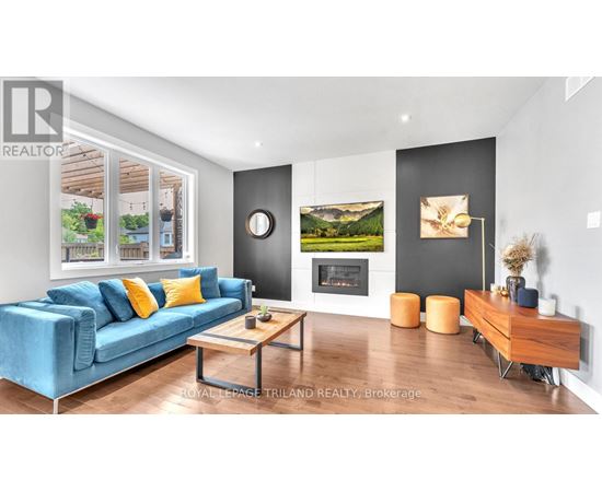 A living room with a blue couch and a fireplace.