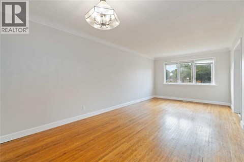 A room with wooden floors and a window.