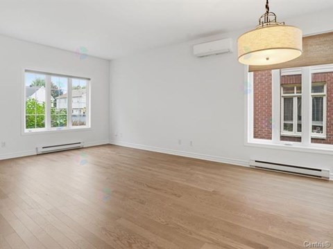 A room with a large window and a wooden floor.
