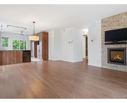 A living room with a fireplace and a television.