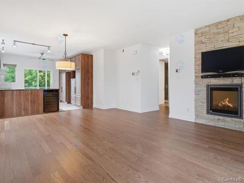 A living room with a fireplace and a television.