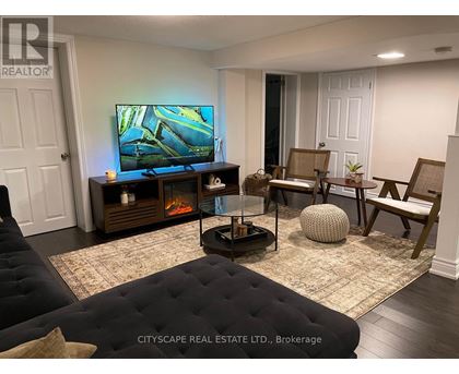 A living room with a television, a fireplace, and a couch.