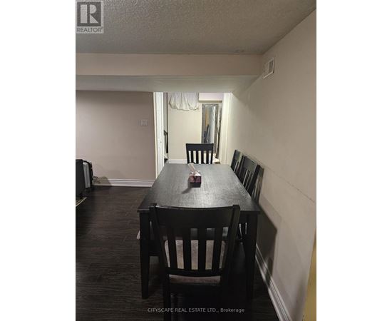 A dining room with a wooden table and chairs.