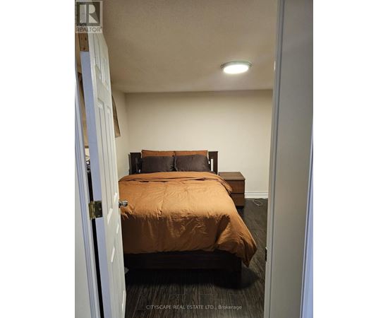 A bedroom with a bed and a bench.