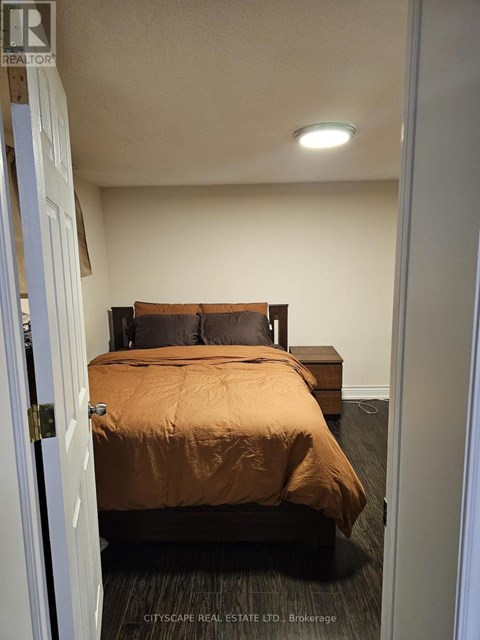 A bedroom with a bed and a bench.