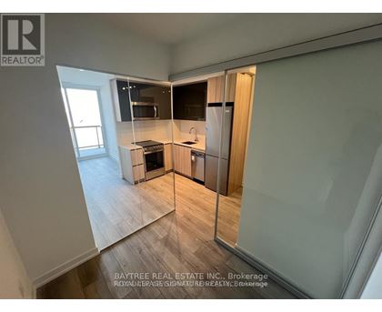 A real estate listing photo of a kitchen with a dining area.