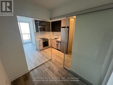 A real estate listing photo of a kitchen with a dining area.