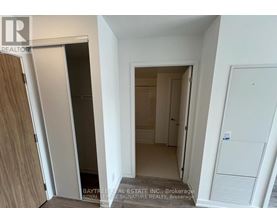 A white hallway with a door on the left and a door on the right.