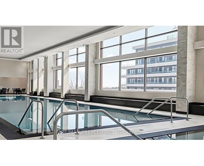 A swimming pool inside a building with a Realtor sign.