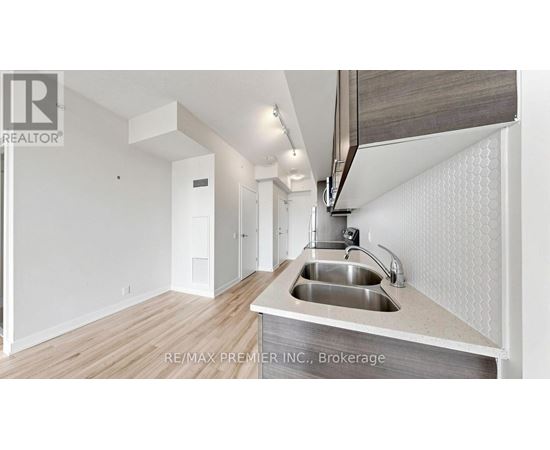 A modern kitchen with a sink and a countertop.