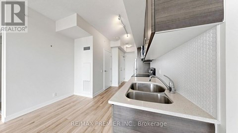 A modern kitchen with a sink and a countertop.