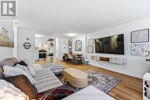 A living room with a couch, a coffee table, and pictures on the wall.