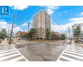 A street view with a crosswalk and a building in the background.