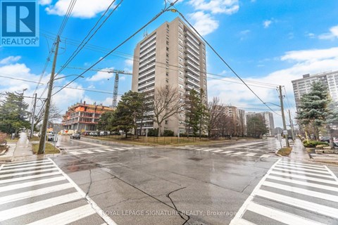 A street view with a crosswalk and a building in the background.