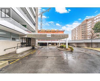 A parking lot with a Royal LePage Signature Realty Brokerage sign.