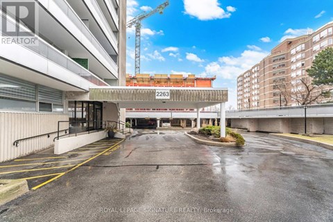 A parking lot with a Royal LePage Signature Realty Brokerage sign.