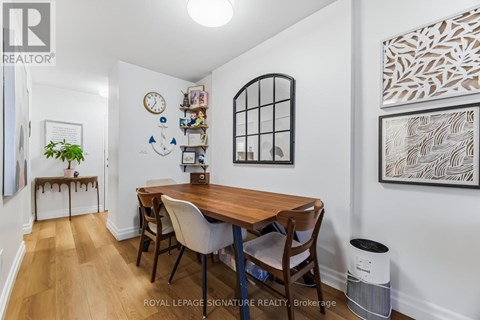 A dining room with a wooden table and chairs.