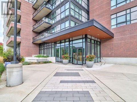 A modern building with a glass entrance and a brick facade.