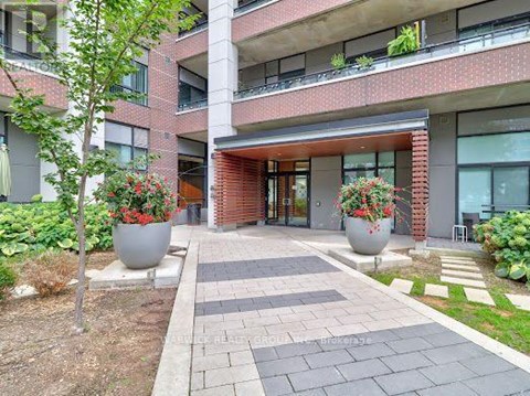 A red brick building with a walkway in front.