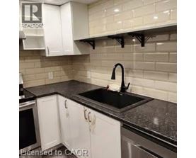 A kitchen with black countertops and white cabinets.