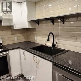 A kitchen with black countertops and white cabinets.