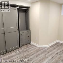 A bedroom with a built-in closet and drawers.