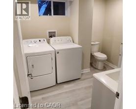 A bathroom with a washer and dryer built into the cabinetry.
