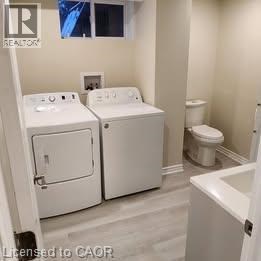 A bathroom with a washer and dryer built into the cabinetry.