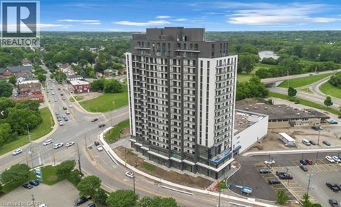 A tall building with a parking lot in front of it.