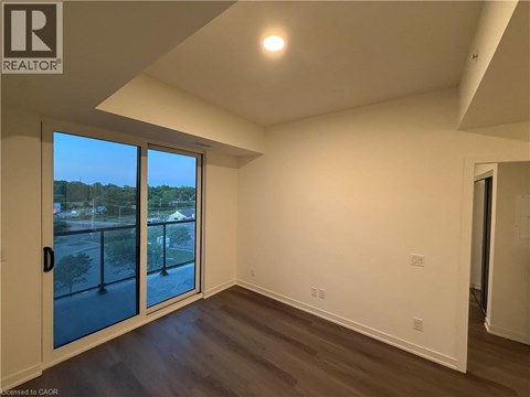 A room with a sliding glass door leading to a balcony.