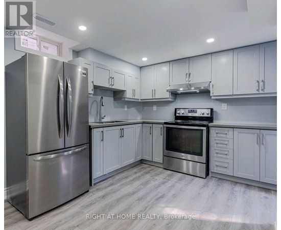 A modern kitchen with stainless steel appliances and white cabinets.