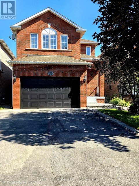 A house with a garage door and a tree in front.