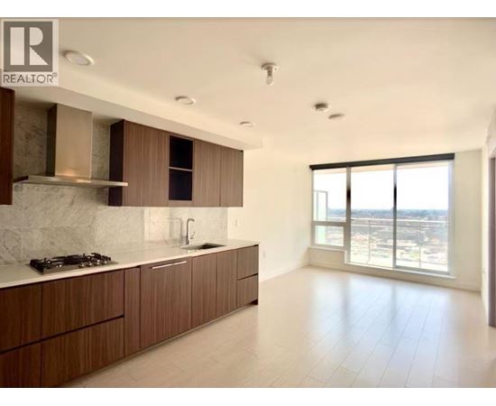 A modern kitchen with wooden cabinets and a marble backsplash.