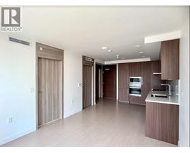 A modern kitchen with wooden cabinets and appliances.