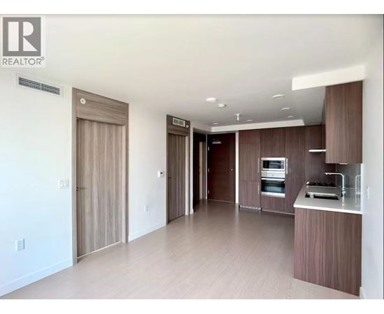 A modern kitchen with wooden cabinets and appliances.